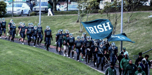 The team walks down to the field with Irish flags raised high!